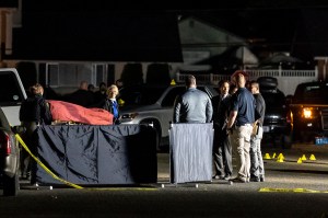 Investigators move the body of Michael Forest Reinoehl after he was shot and killed by law enforcement on September 3, 2020 in Lacey, Washington.