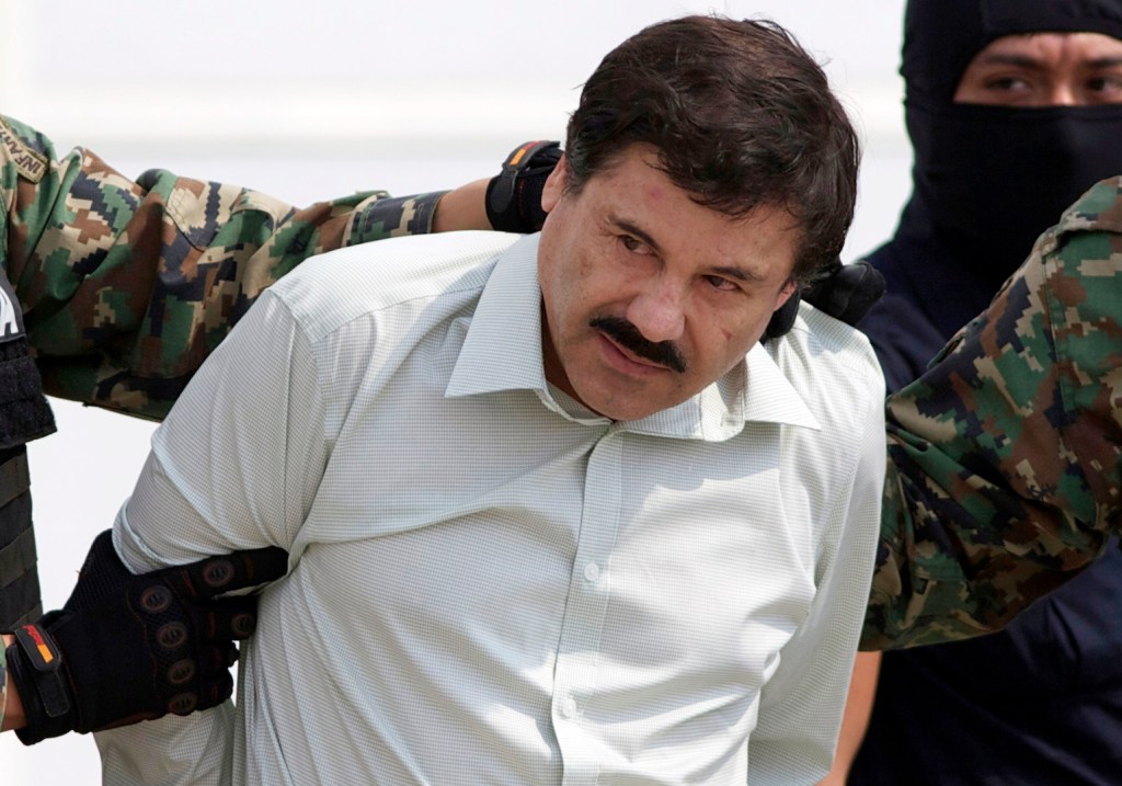 This Feb. 22, 2014 file photo shows Joaquin "El Chapo" Guzman, the head of Mexico's Sinaloa Cartel, being escorted to a helicopter in Mexico City following his capture in the beach resort town of Mazatlan.