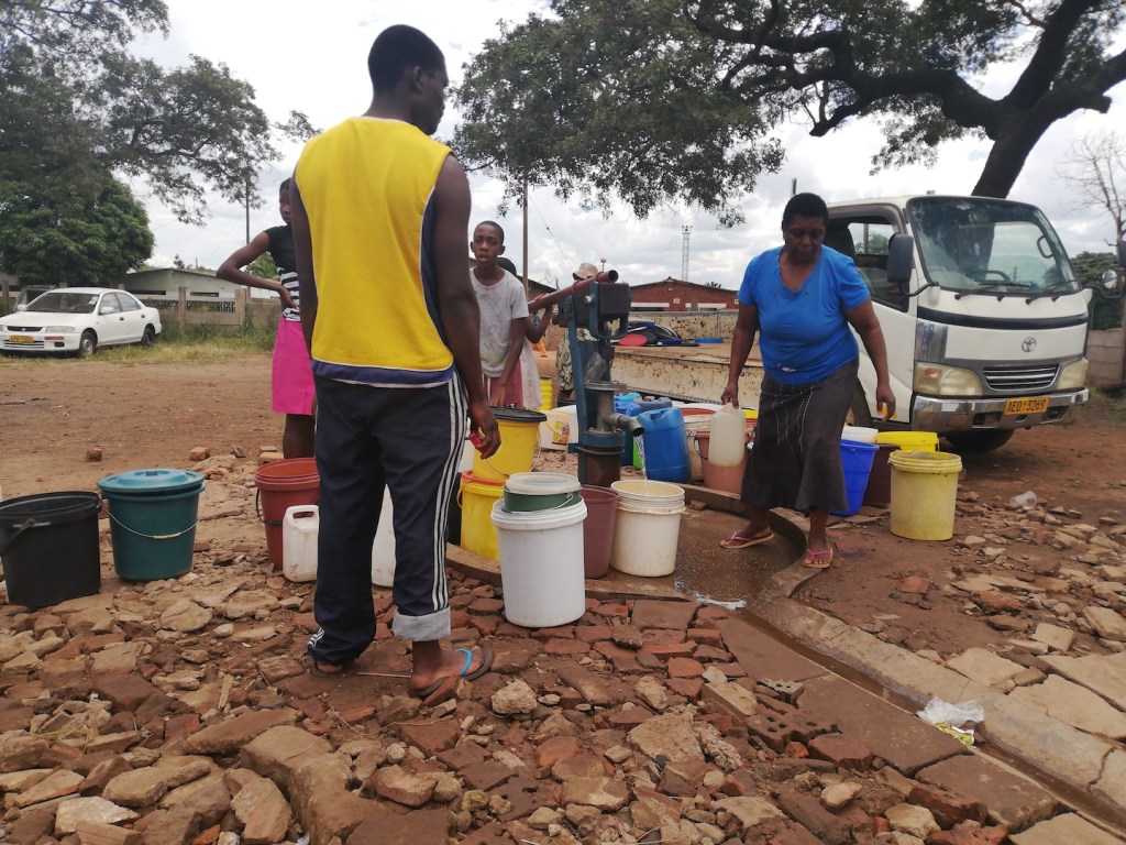 Harare residents fetch water from a community borehole.