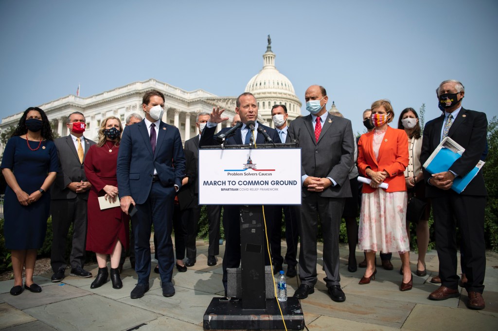 Rep. Josh Gottheimer, D-N.J., joined by other members of the Problem Solvers Caucus, unveils the "March to Common Ground", a COVID-19 relief package, at the House Triangle on Tuesday, Sept. 15, 2020. (Photo by Caroline Brehman/CQ Roll Call via AP Images)