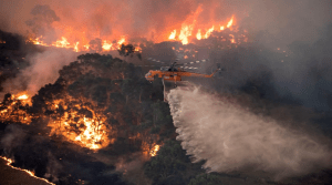 A HELICOPTER FIGHTS A BUSHFIRE NEAR BAIRNSDALE IN VICTORIA'S EAST GIPPSLAND REGION ON DECEMBER 31ST, 2019.