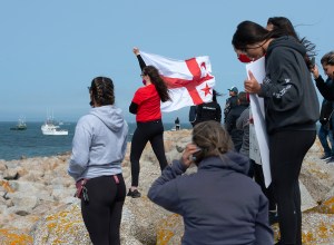 Mi'kmaq fishermen and supporters stand as commercial fishermen protest