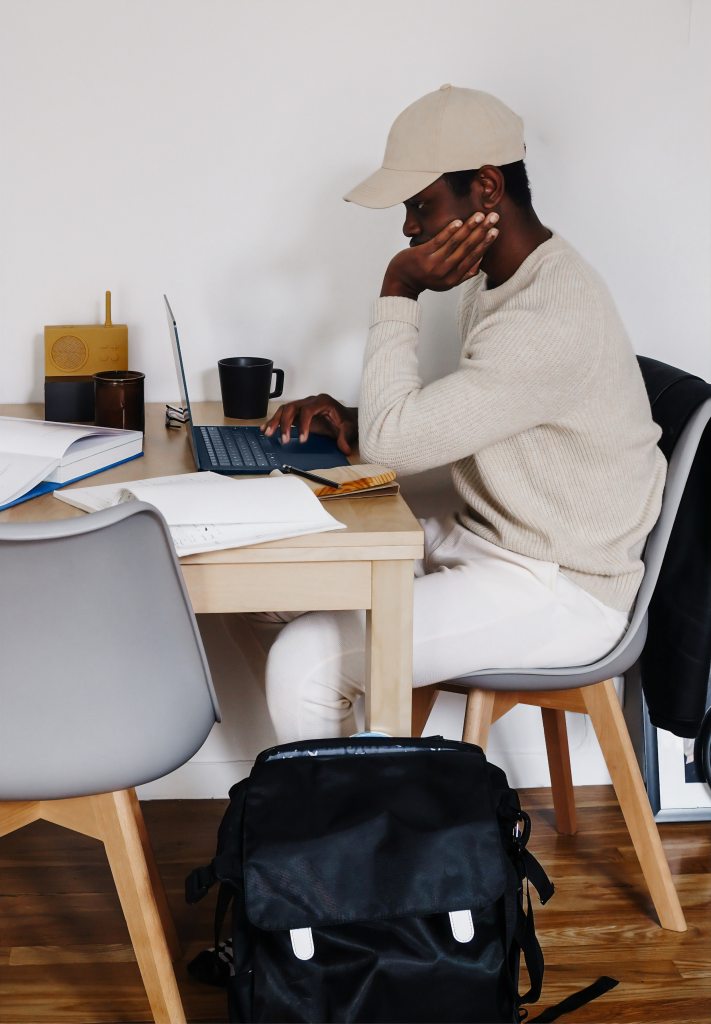 man sitting at a desk with a computer