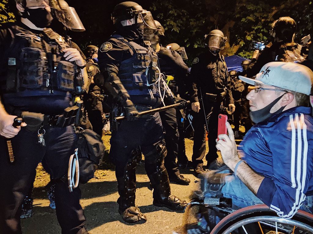 Dustin Brandon staring down police before he was arrested on September 28, 2020, in Portland, Oregon. (Tess Owen/VICE News)