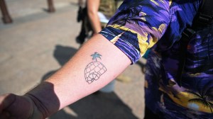 A 'Boogaloo Boy' shows his 'big igloo' tattoo, which is slang for 'the boogaloo' i.e. a second civil war. Columbus, Ohio, US, on July 18th, 2020. (Photo by Zach D Roberts/NurPhoto via Getty Images)