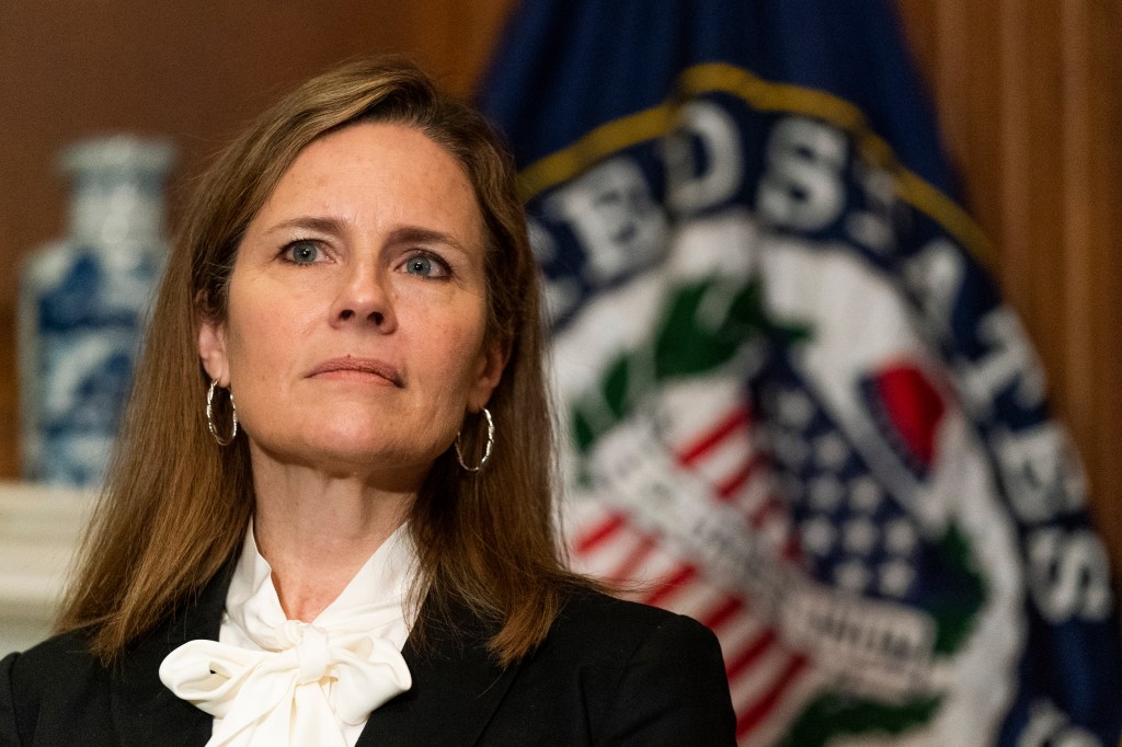 Supreme Court nominee Judge Amy Coney Barrett listens as Sen. Jerry Moran, R-Ks., not shown, speaks during their meeting on Capitol Hill, Thursday, Oct. 1, 2020, in Washington. (AP Photo/Manuel Balce Ceneta, POOL)