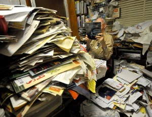 Old man surrounded by junk mail