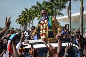 Tundu Lissu, who was shot 16 times in a 2017 attack, reacts to supporters as he returns after three years in exile to challenge President John Magufuli.