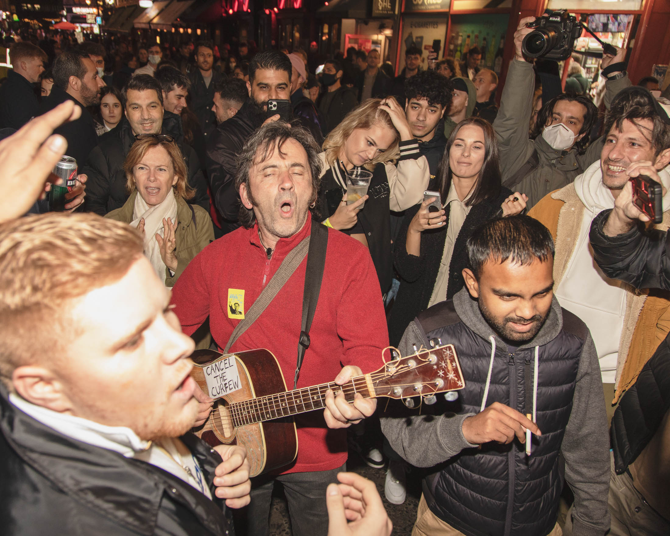 A mass singalong in Soho in London one the last night before new Tier 2 lockdown measures