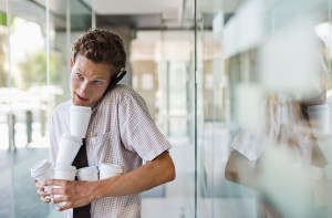 Office intern balancing cups of coffee