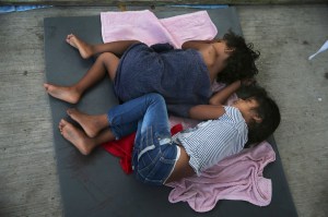 In this July 17, 2019 file photo, migrant children sleep on a mattress on the floor of the AMAR migrant shelter in Nuevo Laredo, Mexico. (AP Photo/Marco Ugarte, File)​