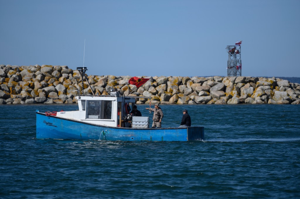 Mi'kmaq fishers are seen just outside the wharf in Saulnierville, N.S. on Sunday, October 18, 2020.