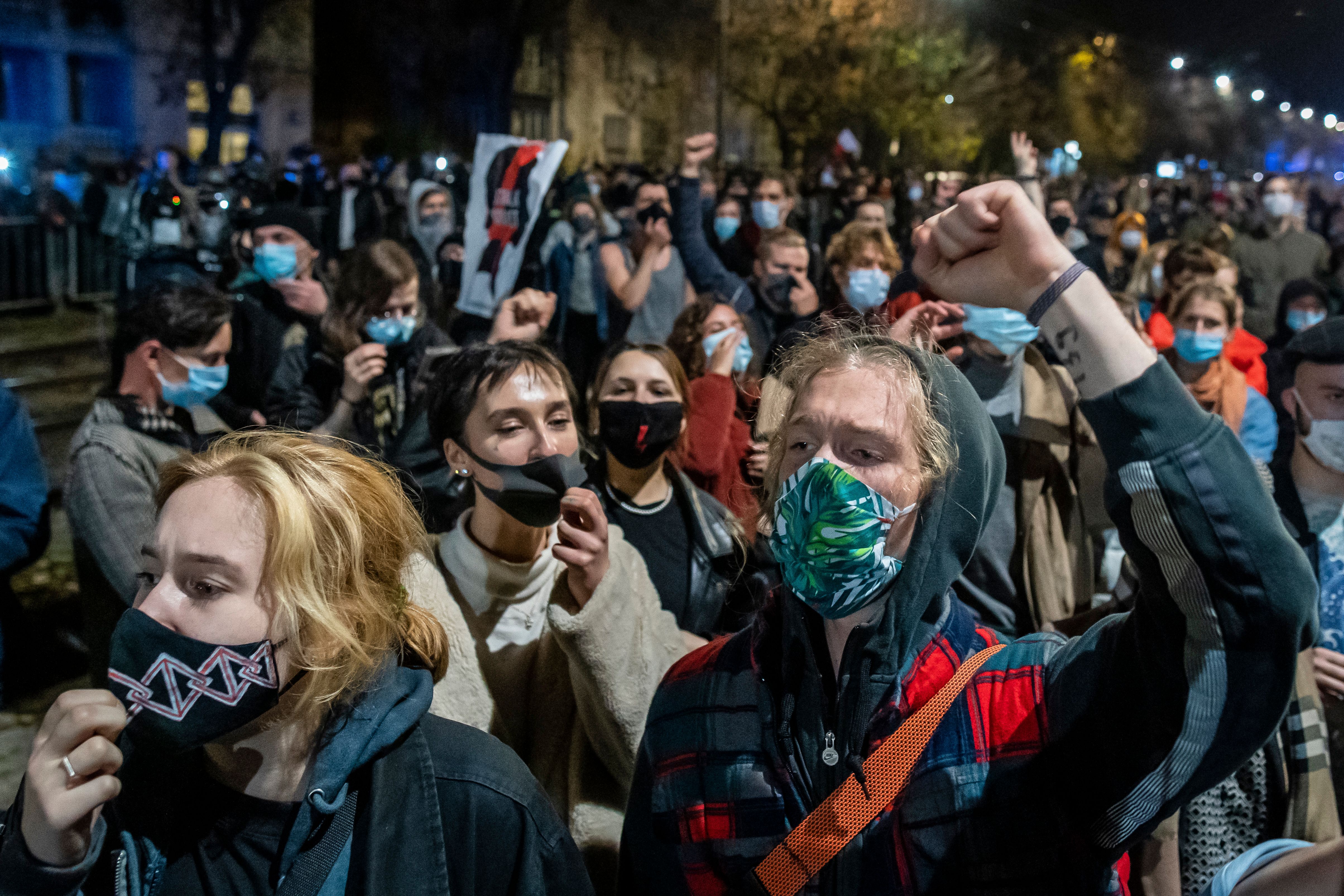 Protestors shout slogans as they are blocked by riot police guarding the house of Jaroslaw Kaczynski, leader of Poland's ruling Law and Justice party (PIS) during a demonstration against a decision by the Constitutional Court on abortion law restriction i