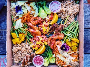 a pizza box full of meat, shrimp, vegetables, and rice from the kamayan box pop-up