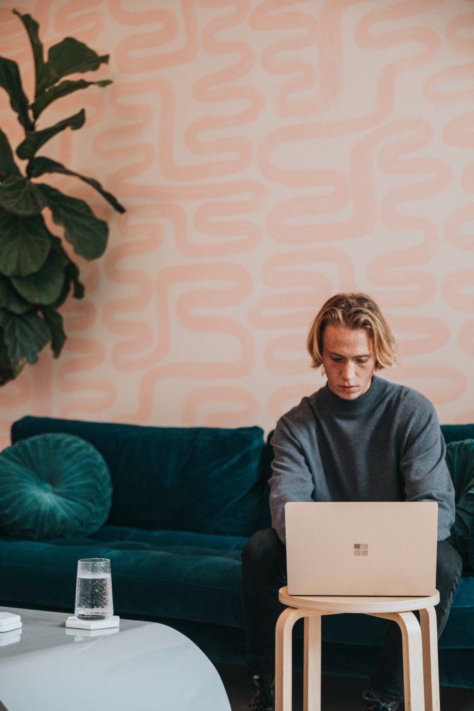 Man works on his laptop from his couch