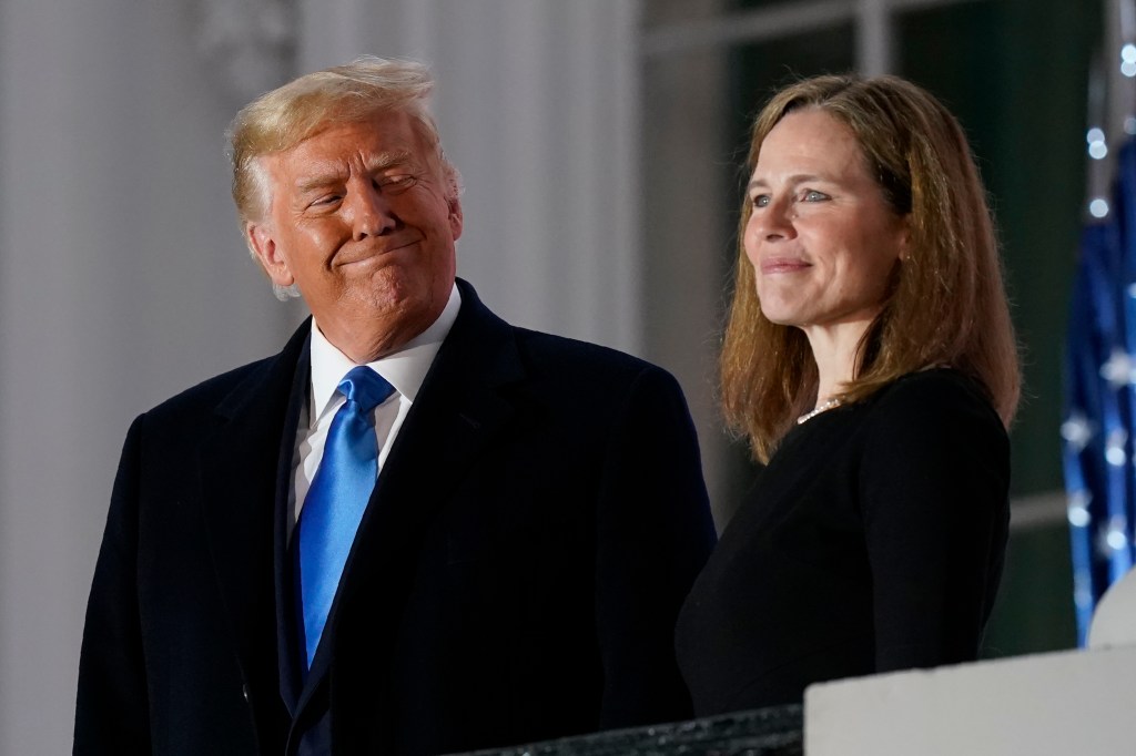 President Donald Trump and Amy Coney Barrett stand on the Blue Room Balcony after Supreme Court Justice Clarence Thomas administered the Constitutional Oath to her on the South Lawn of the White House White House in Washington, Monday, Oct. 26, 2020.