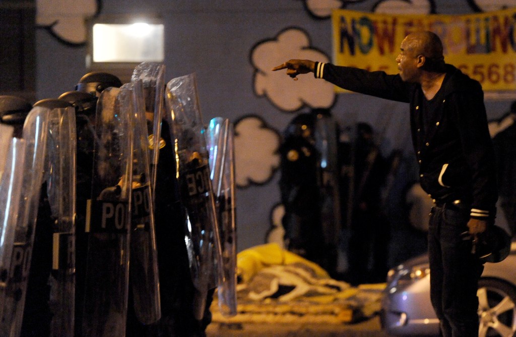 A protester points while facing police during a demonstration Tuesday night, Oct. 27, 2020, in Philadelphia (AP Photo/Michael Perez)​