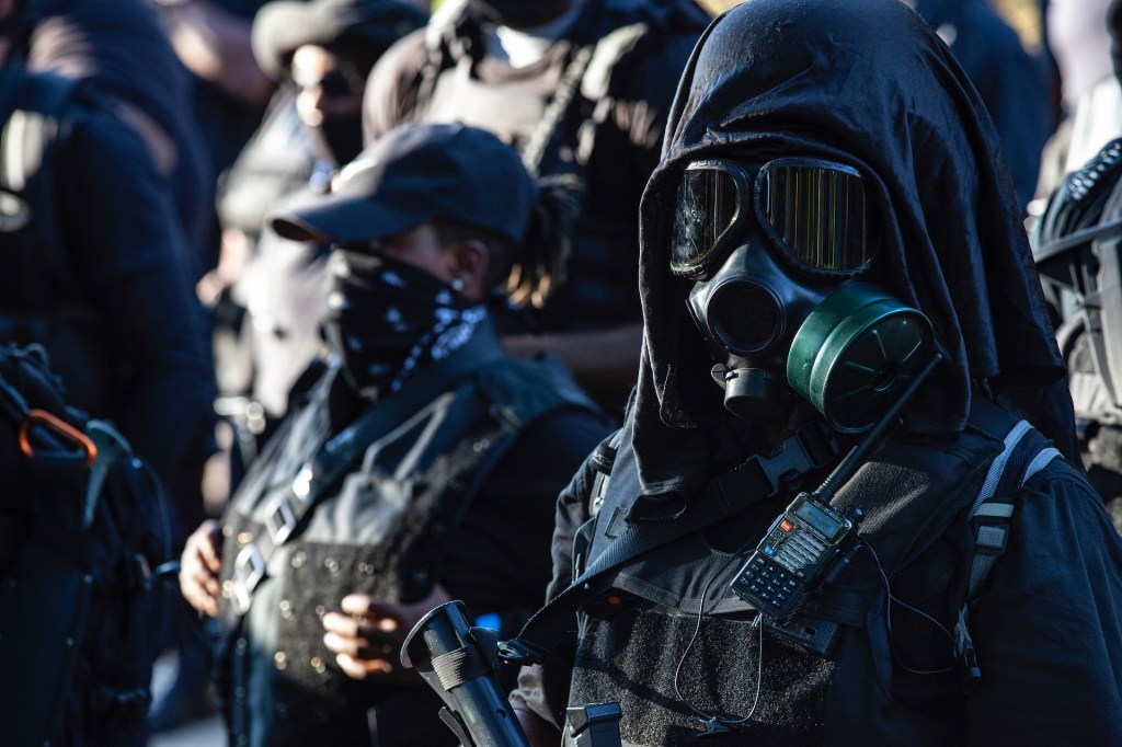 Members of the Not Fucking Around Coalition (NFAC), a Black militia, stand in ranks during a demonstration in front of Churchill Downs, the site of the Kentucky Derby, in Louisville, Kentucky, on September 5, 2020.