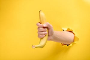 hand holding a banana