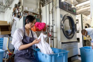 Woman does laundry professionally.