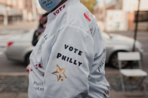 An election official wears a jacket reading "Vote Philly" outside a polling location for the 2020 Presidential election in Philadelphia, Pennsylvania, U.S., on Tuesday, Nov. 3, 2020.