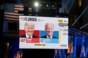 Florida election results are displayed on a screen ahead of an election night party for Joe Biden in Delaware.