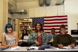 A class of students with varying gender identities laughing