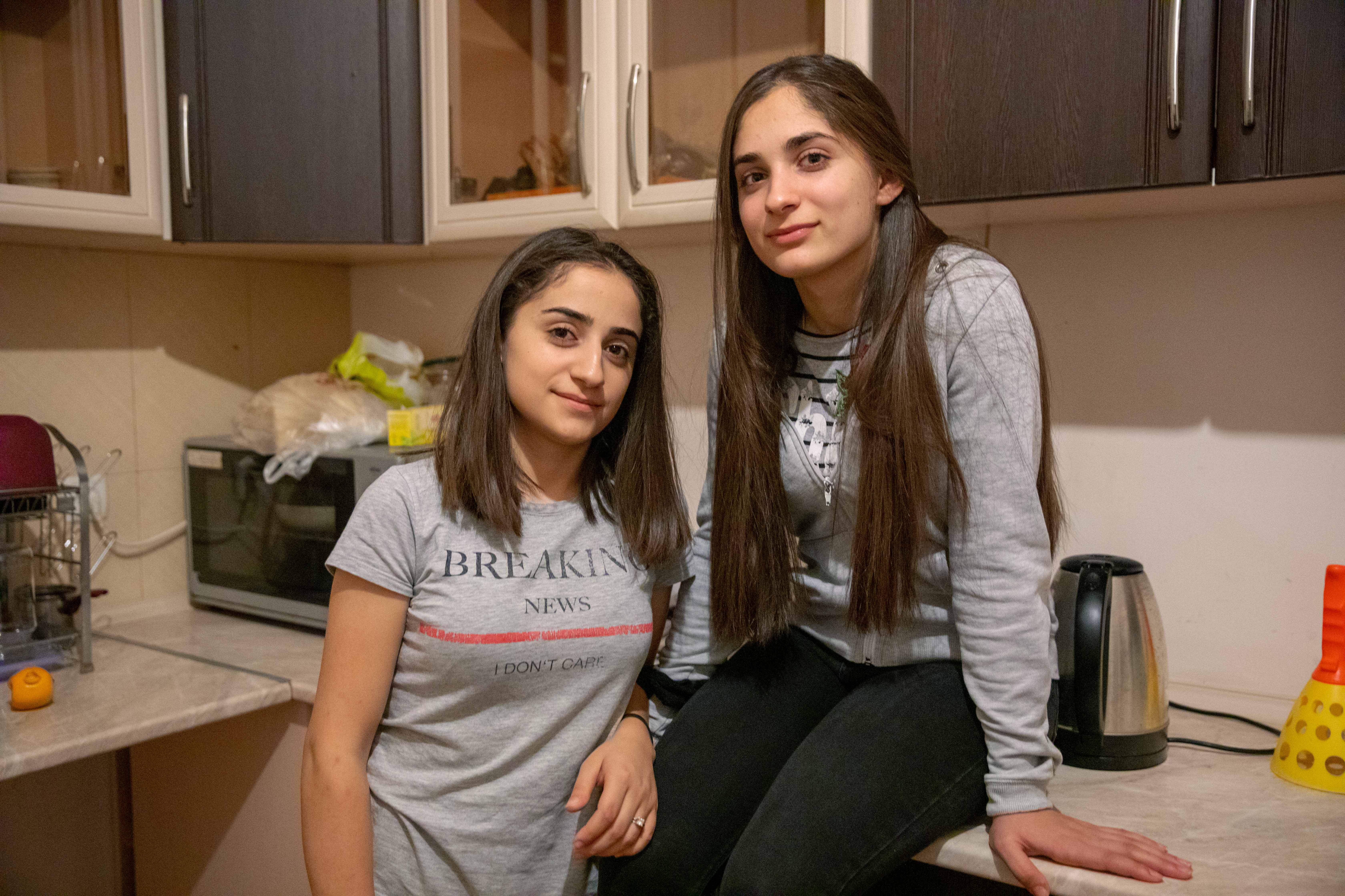 sisters Arevik Sarikyan, 17 (left) and Lusine Sarikyan, 16 in the house where they have been staying in Yerevan