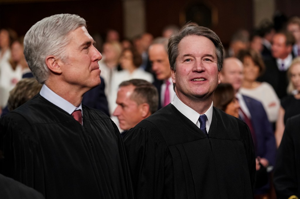 Supreme Court Associate Justices Neil Gorsuch, left, and Brett Kavanaugh watch as President Donald Trump arrives to give his State of the Union address to a joint session on Congress at the Capitol, Tuesday, Feb. 5, 2019 in Washington.