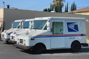 United States Postal trucks are parked at the U.S. Post Office East Los Angeles Branch, Tuesday, Aug. 26, 2020, in Los Angeles. (Kirby Lee via AP)