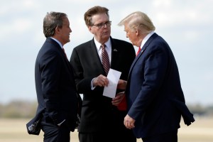 President Donald Trump talks Texas Lt. Gov. Dan Patrick, center, and Attorney General Ken Paxton, Wednesday, Nov. 20, 2019, in Austin. (AP Photo/ Evan Vucci)​