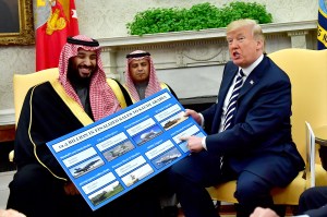 Donald Trump holds up a chart of military hardware sales as he meets with Crown Prince Mohammed bin Salman in the Oval Office in 2018.