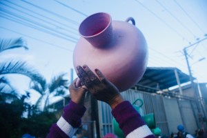 A demonstrator holds up a pitcher while protesting due to water shortages on August 20, 2020 in San Salvador, El Salvador.