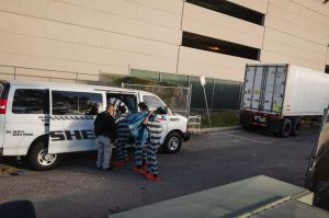 El Paso County detention inmates on work release climb into a transport van after working at the Medical Examiner's office in El Paso, Texas on November 13, 2020.