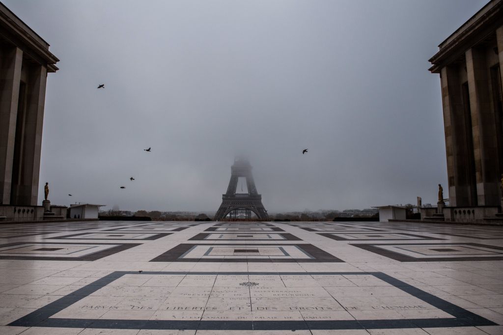 The empty Trocadero esplanade and the Eiffel Tower partially hidden by fog in Paris, as France entered a second lockdown.