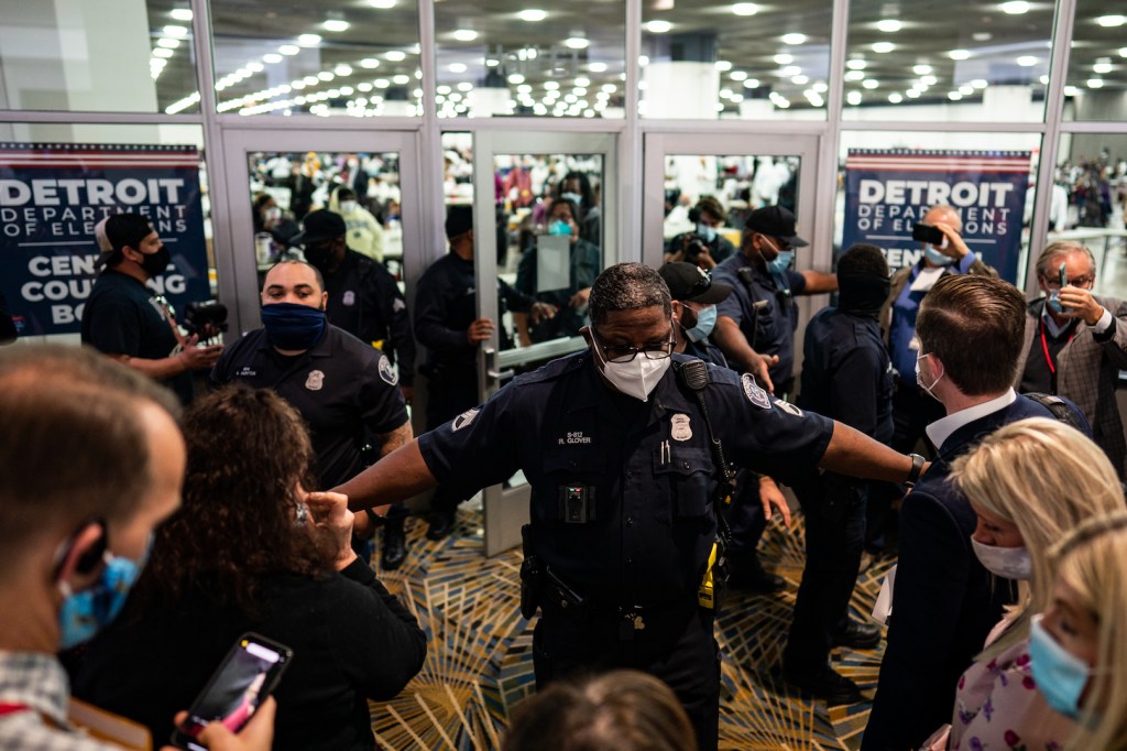 Election challengers demand to enter to observe the absentee ballot counting but were blocked after the room reached capacity during the 2020 general election in Detroit, Michigan on Wednesday, Nov. 4, 2020.