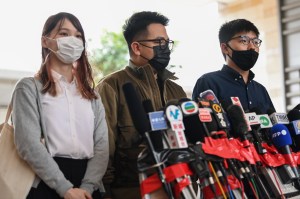 Agnes Chow, Ivan Lam and Joshua Wong speak to the media at the West Kowloon Magistrates Court. PHOTO: PETER PARKS / AFP