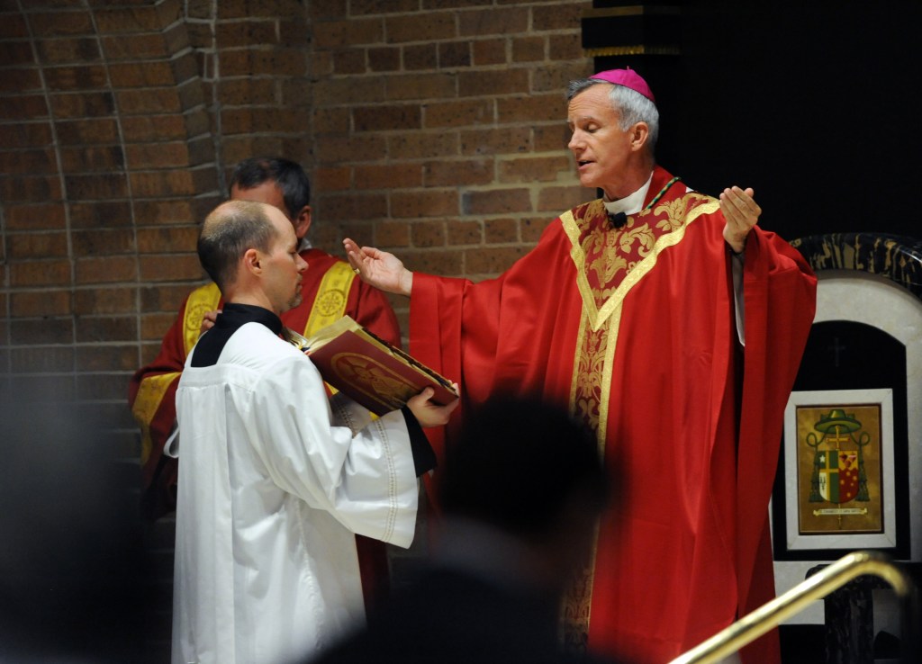 Bishop Joseph E. Strickland reads at the beginning of Red Mass at the Cathedral of the Immaculate Conception.