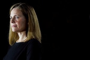 In this Oct. 26, 2020, file photo Amy Coney Barrett, listens as President Donald Trump speaks before Supreme Court Justice Clarence Thomas administers the Constitutional Oath to Barrett on the South Lawn of the White House in Washington, after she was con