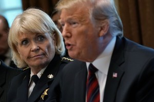 U.S. President Donald Trump (R) speaks as Sheriff Carolyn "Bunny" Welsh (L) of Chester County of Pennsylvania listens during a round-table discussion on border security and safe communities with State, local, and community leaders in the Cabinet Room of t