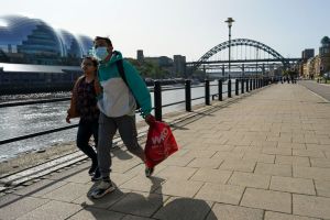 A couple walk along Newcastle quayside​.