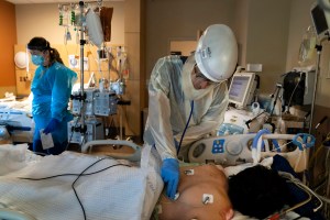 In this Nov. 19, 2020, file photo, medical personnel prone a COVID-19 patient at Providence Holy Cross Medical Center in the Mission Hills section of Los Angeles. (AP Photo/Jae C. Hong, File)​