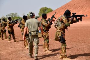 An Army trainer instructs people in weapons use.