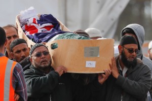 Mourners carry the body of a victim of the March 15 mosque shootings for a burial at the Memorial Park Cemetery in Christchurch, New Zealand, Friday, March 22, 2019. (AP Photo/Vincent Thian)​