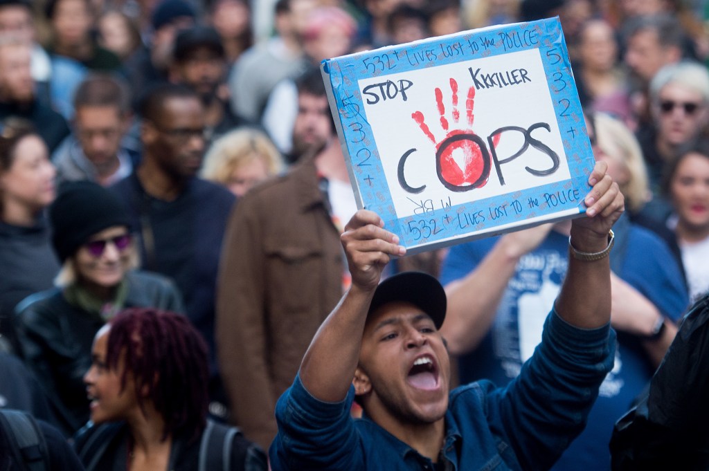 A demonstrator yells while marching with hundreds of protesters against the recent fatal shootings by police of black men in San Francisco on Friday, July 8, 2016. The peaceful group marched about two miles to San Francisco City Hall.