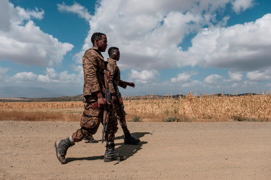 Two members of the Ethiopian Defense Force walk in Tigray.