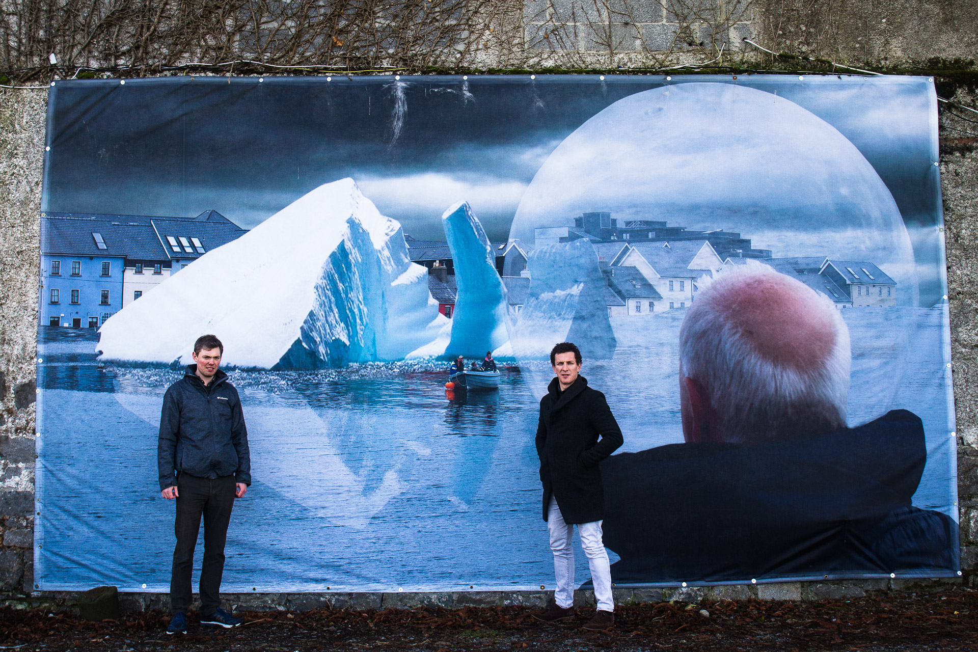 Gerry Liston & Gearoid O Cuinn pose in front of a climate-themed artwork in Galway Global Legal Action Network LawyersIMG_7776.jpg