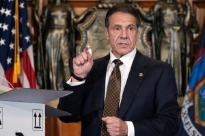 In this Dec. 3, 2020, photo provided by the Office of Gov. Andrew Cuomo, Cuomo holds up samples of empty packaging for the COVID-19 vaccine during a news conference in the Red Room at the State Capitol in Albany, N.Y.