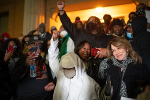 On the steps of Stillwater Prison, Myon Burrell raised his fist while one of his lawyers, Perry Moriearty​.