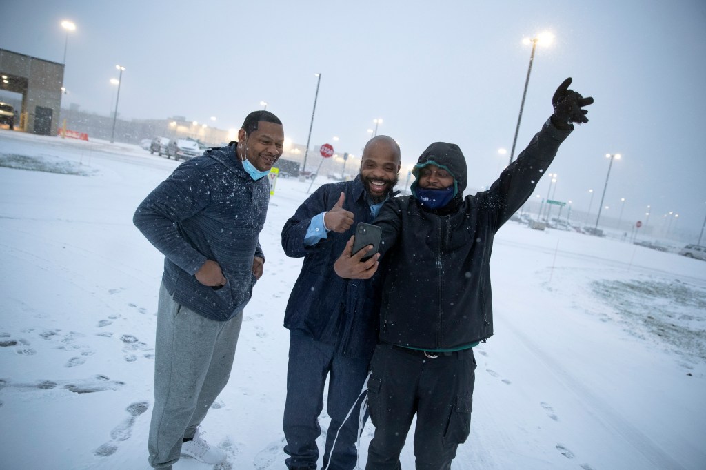 Termaine Hicks, center, celebrates with his brothers Tone Hicks and Tyron McClendon after he was released from SCI Phoenix Prison Wednesday, Dec. 16, 2020, in Collegeville, Pa. (Jason E. Miczek/AP Images for The Innocence Project)​